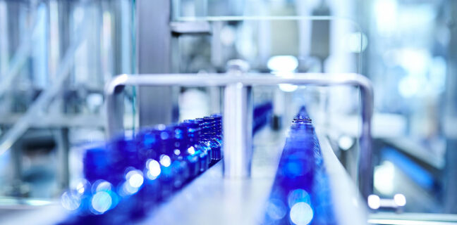 Blue Bottle at Filling in Conveyor Belt