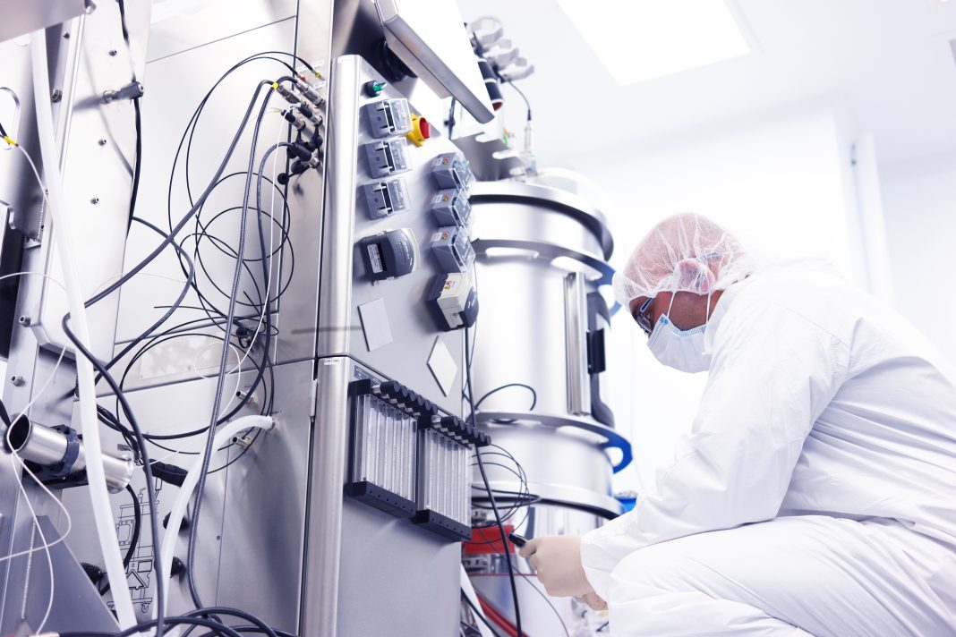 scientist with bioreactor
