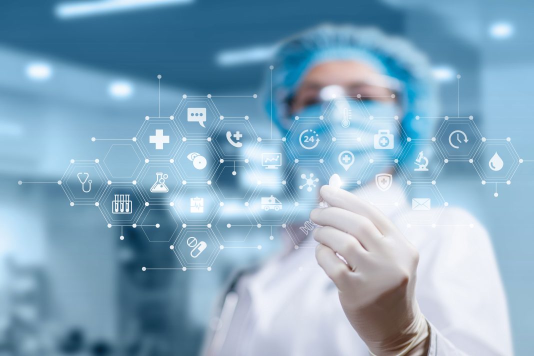 Doctor shows a pill on the background of the medical icons
